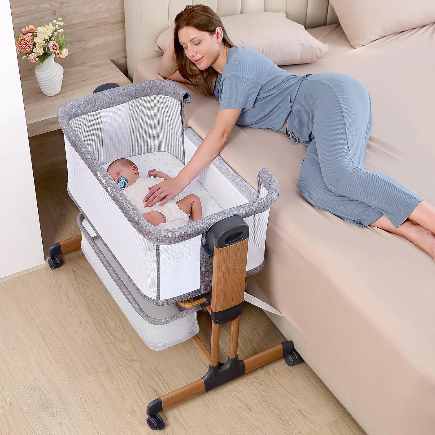 Modern 3-in-1 white bassinet with mesh sides, wheels, and adjustable height for bedside sleeping — view 2