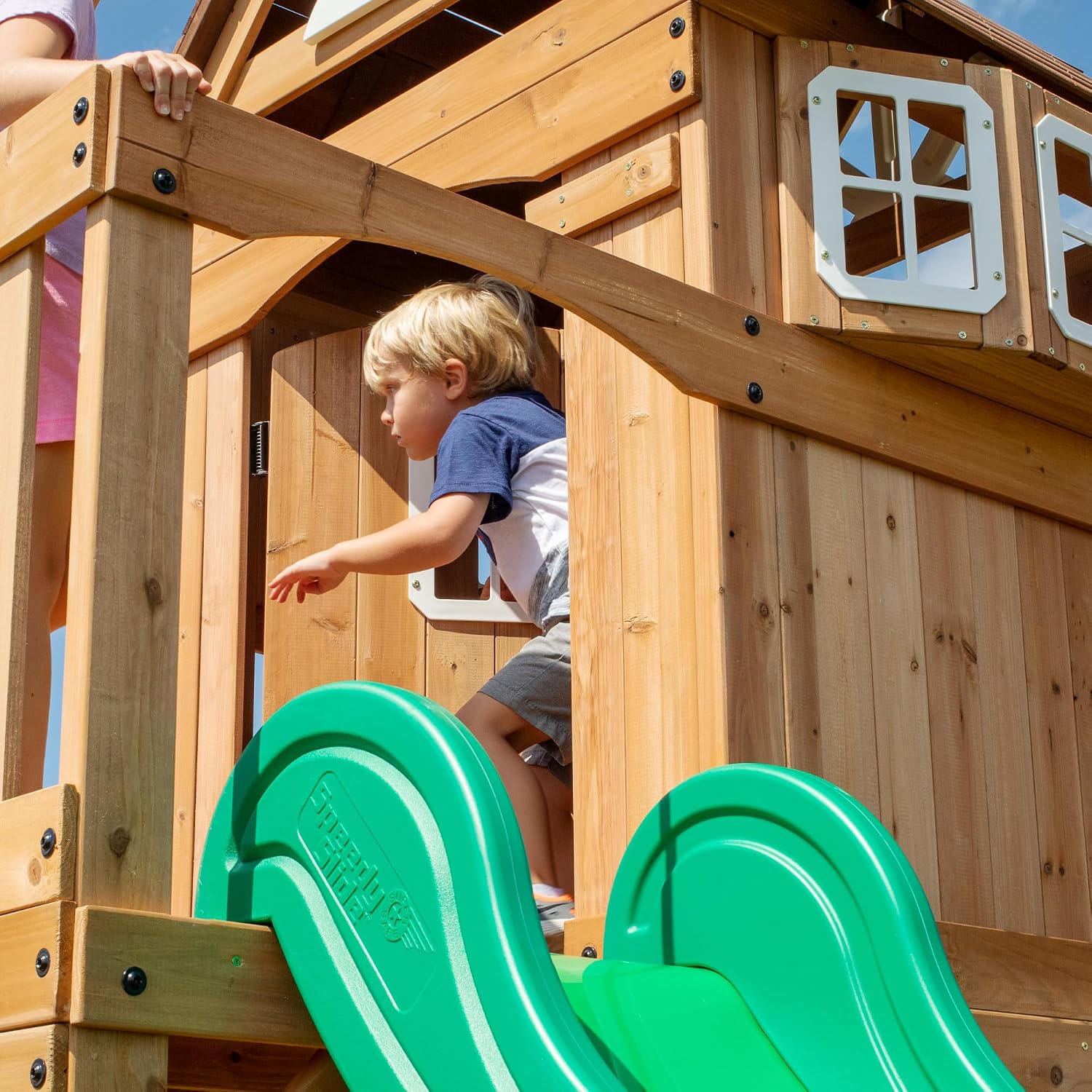 Cedar wood swing set with attached wave slide, clubhouse with working door, monkey bars, and dual belt swings — view 5