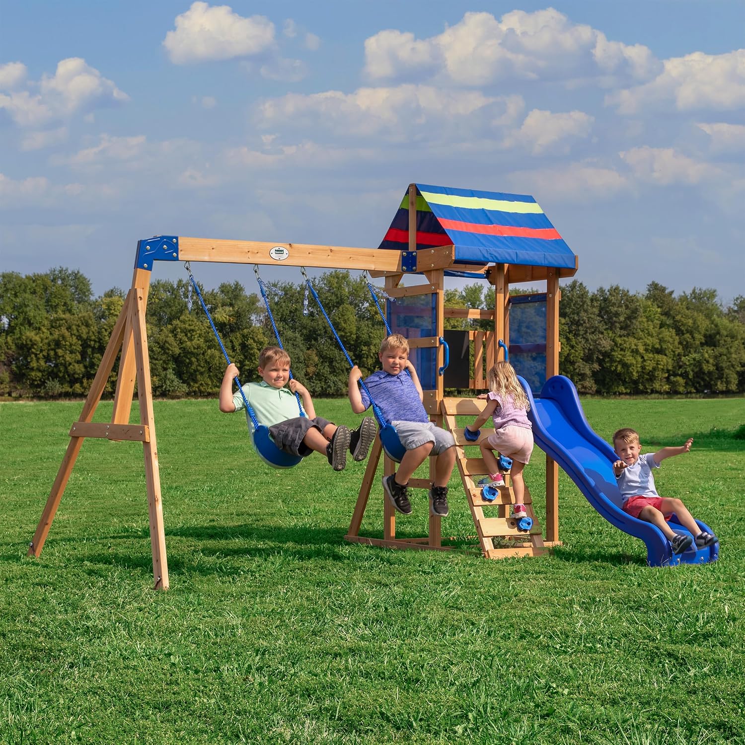 Cedar wood swing set with wave slide, tan canopy roof, and rock wall ladder for toddlers and preschoolers — front