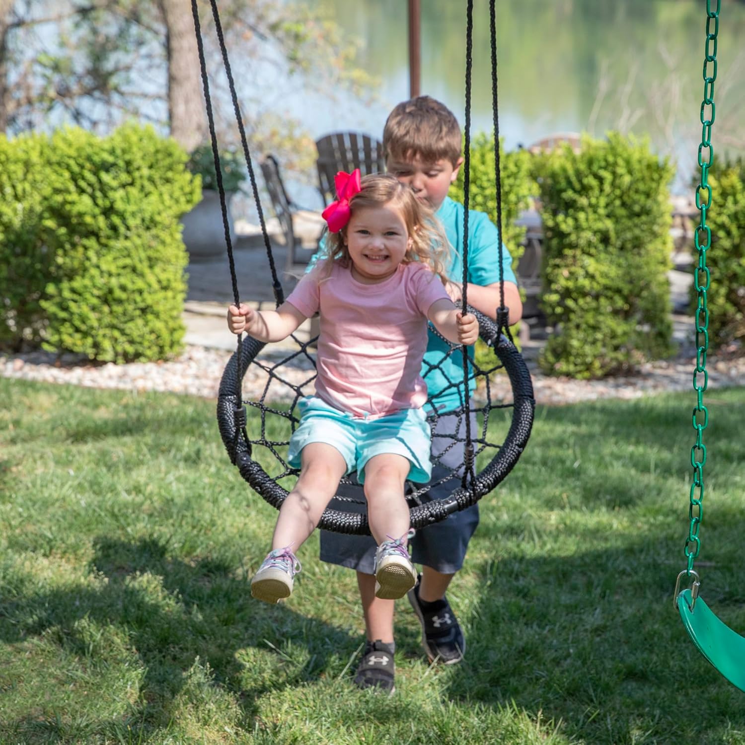 Cedar wood outdoor swing set with integrated wave slide, double rock wall, web swing, and elevated play deck for children ages 3-8 — view 4