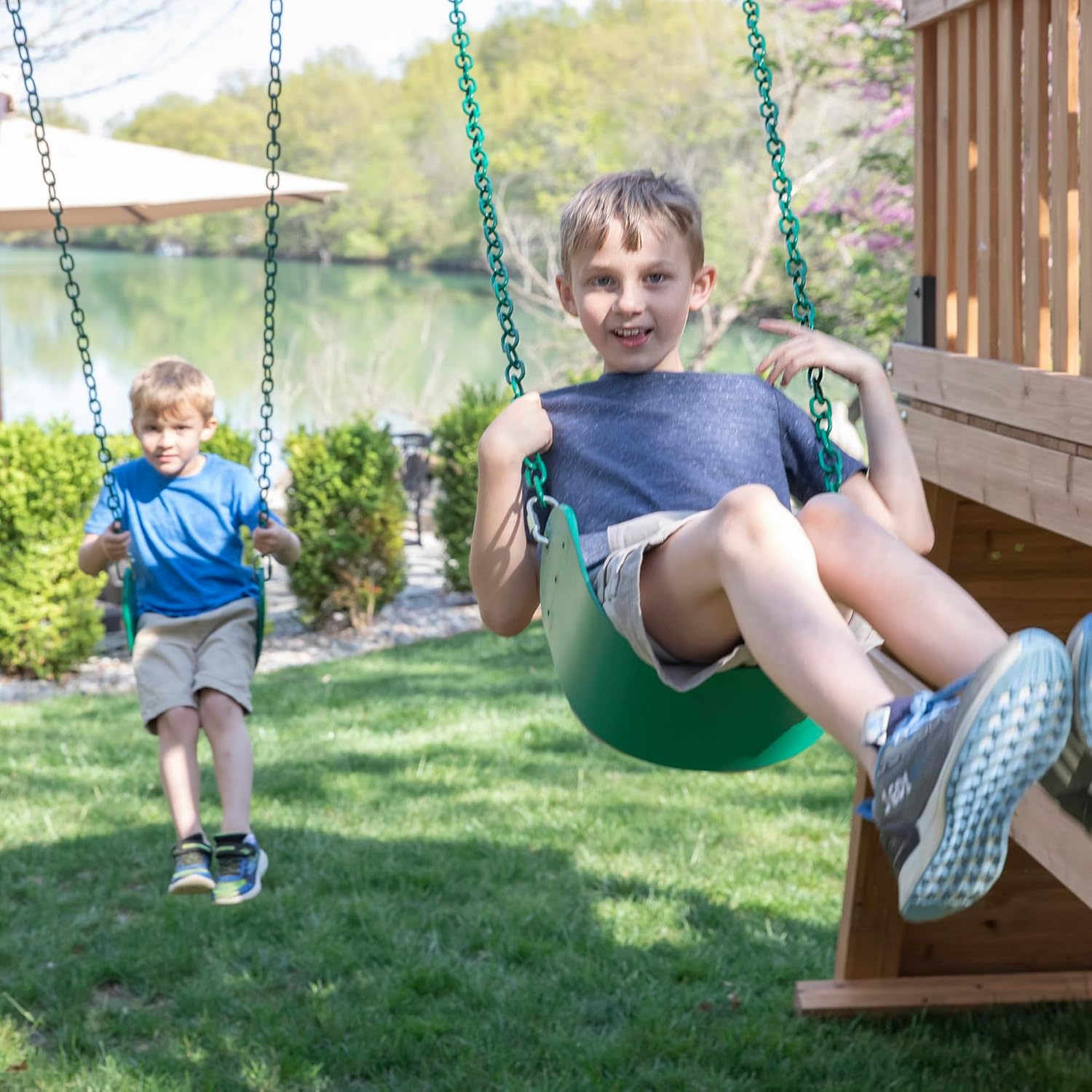 Cedar wood outdoor swing set with integrated wave slide, double rock wall, web swing, and elevated play deck for children ages 3-8 — view 5