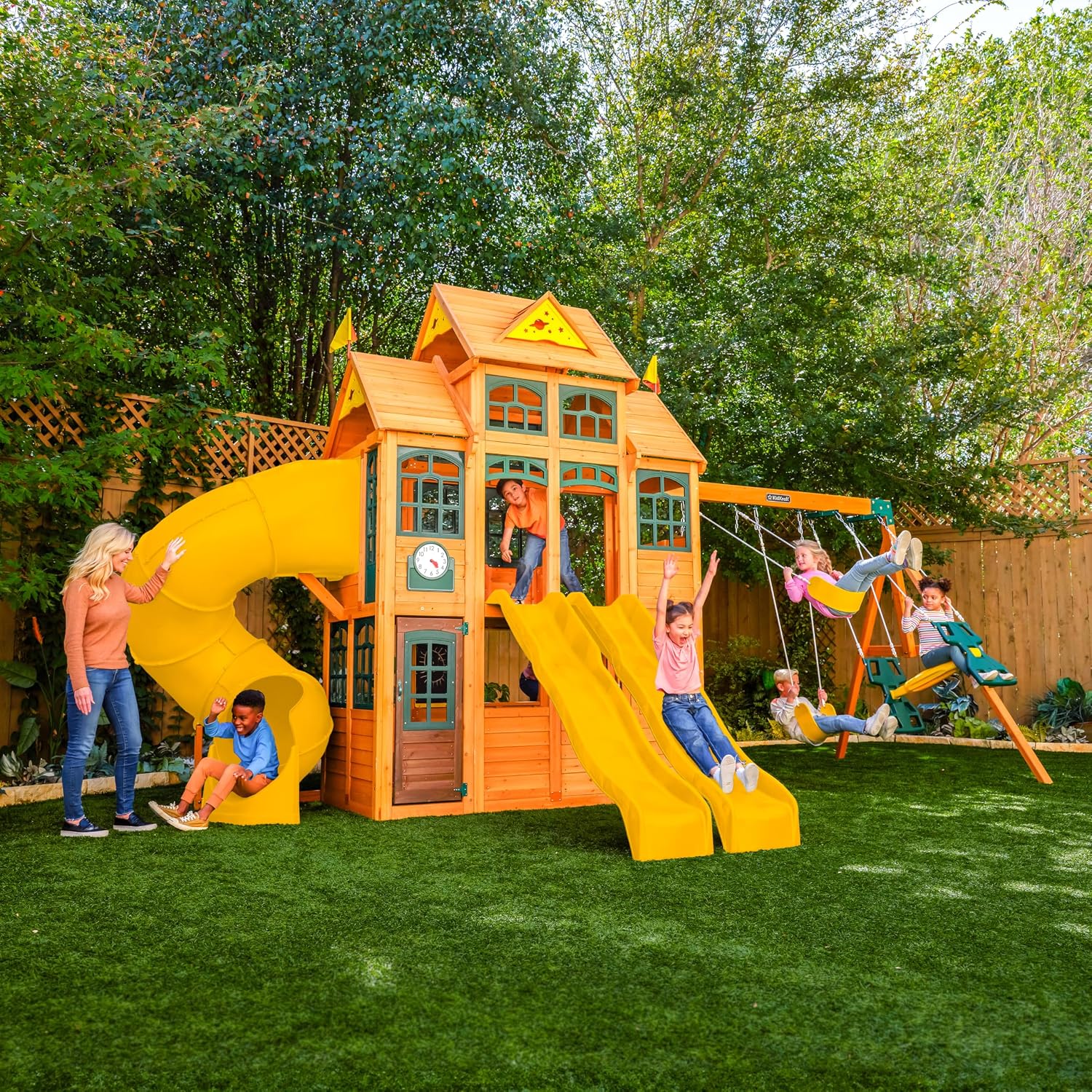 Wooden outdoor swing set with three slides, climbing wall, glider, and integrated play kitchen with cafe window for preschoolers — view 2