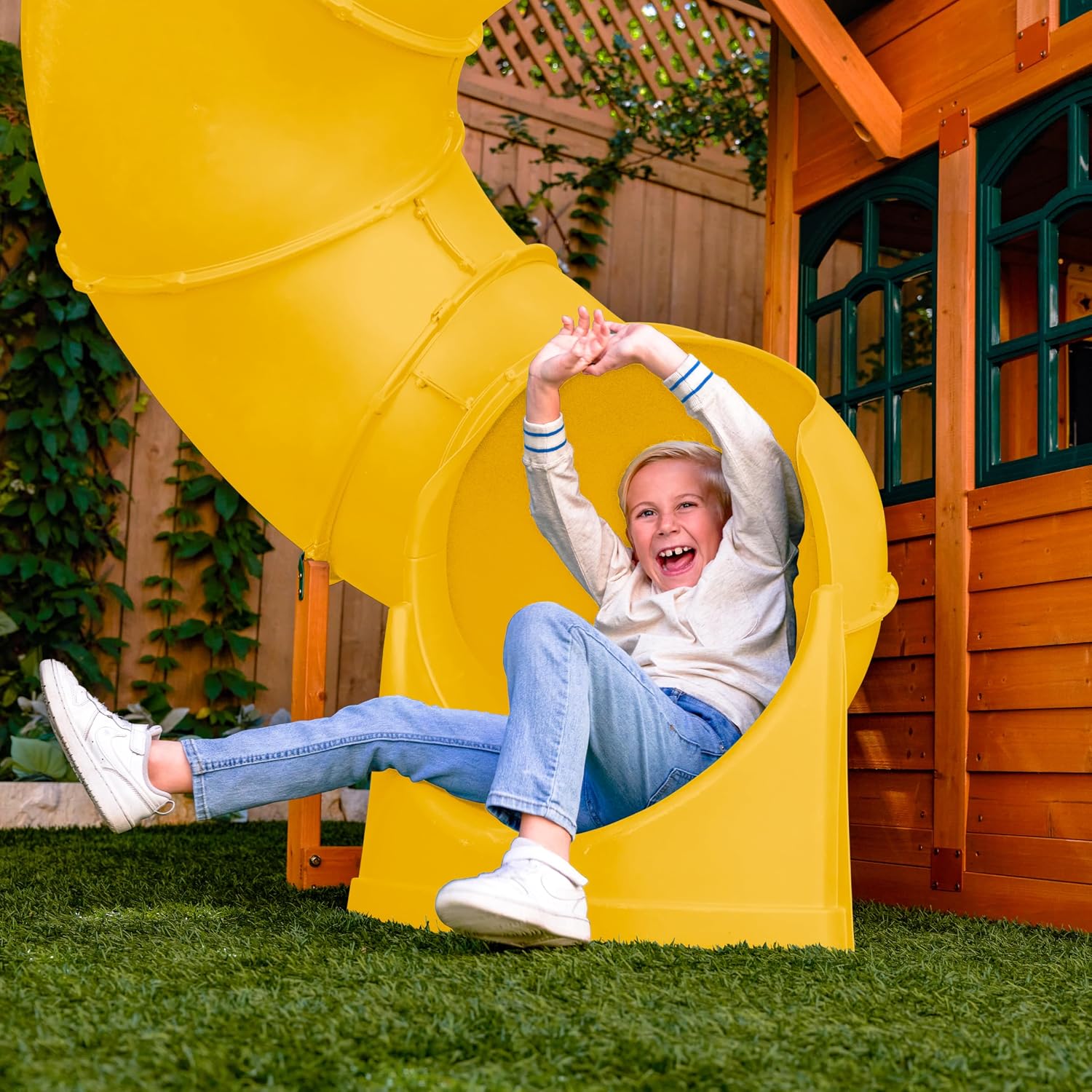 Wooden outdoor swing set with three slides, climbing wall, glider, and integrated play kitchen with cafe window for preschoolers — view 4