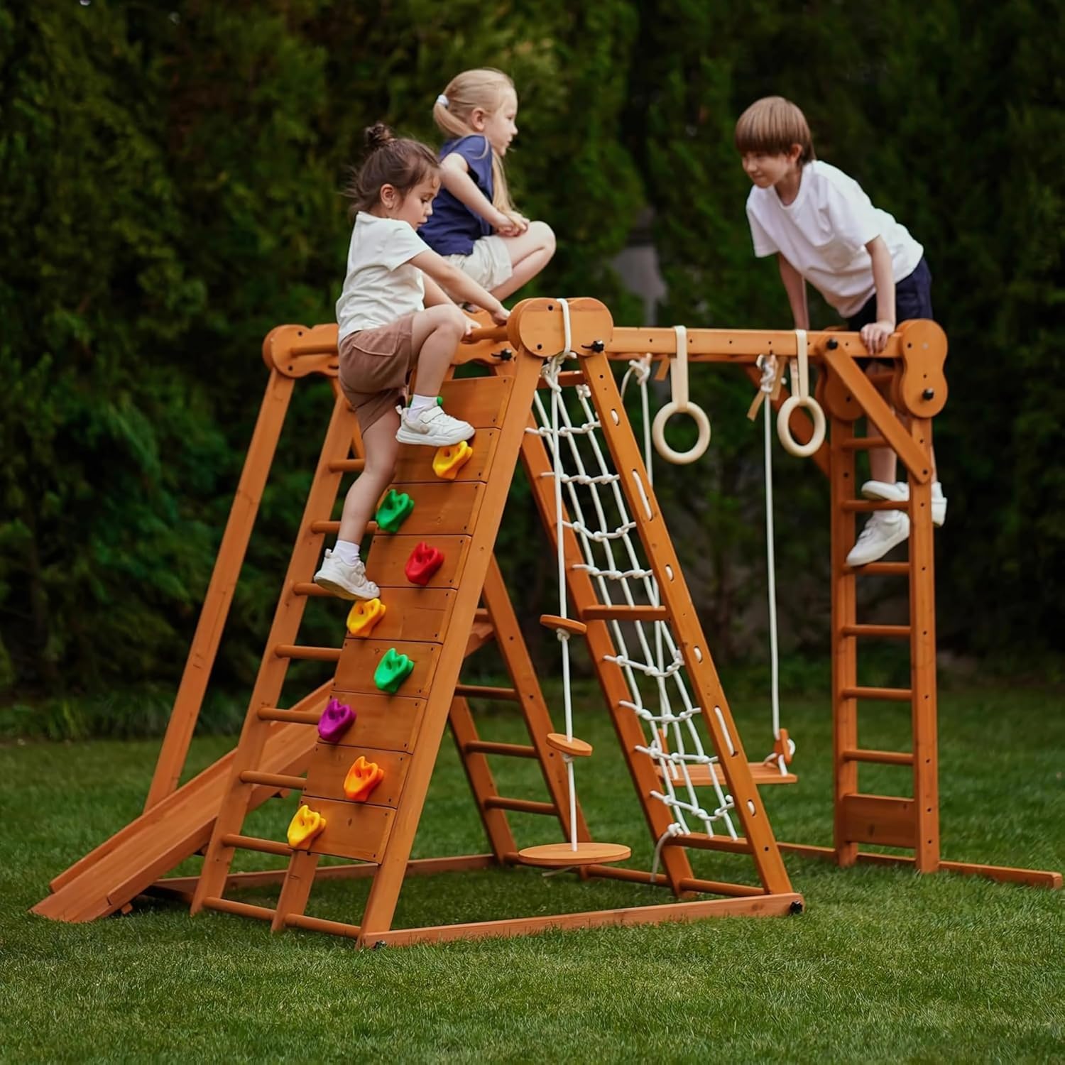 Natural wood 8-in-1 playset with slide, monkey bars, two swings, rock climbing wall, and gym rings for toddlers — front