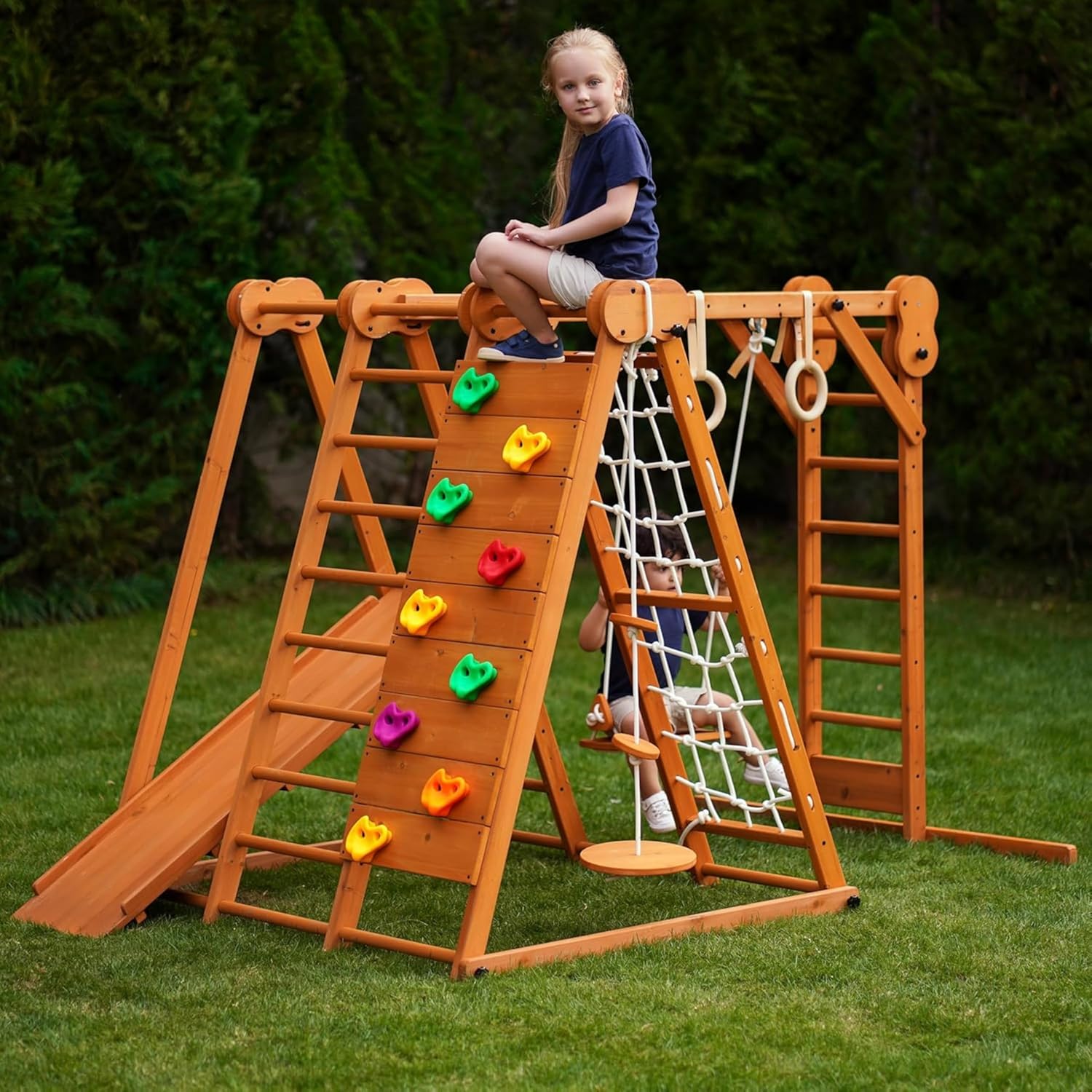 Natural wood 8-in-1 playset with slide, monkey bars, two swings, rock climbing wall, and gym rings for toddlers — view 2