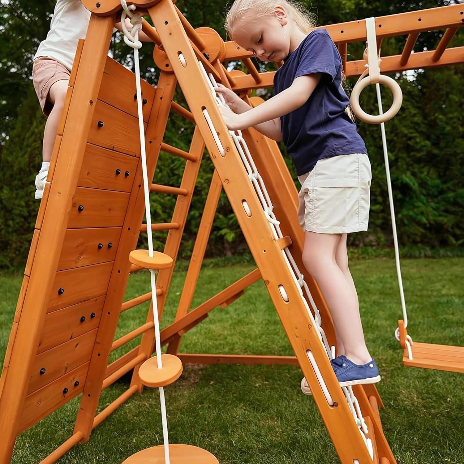 Natural wood 8-in-1 playset with slide, monkey bars, two swings, rock climbing wall, and gym rings for toddlers — view 5