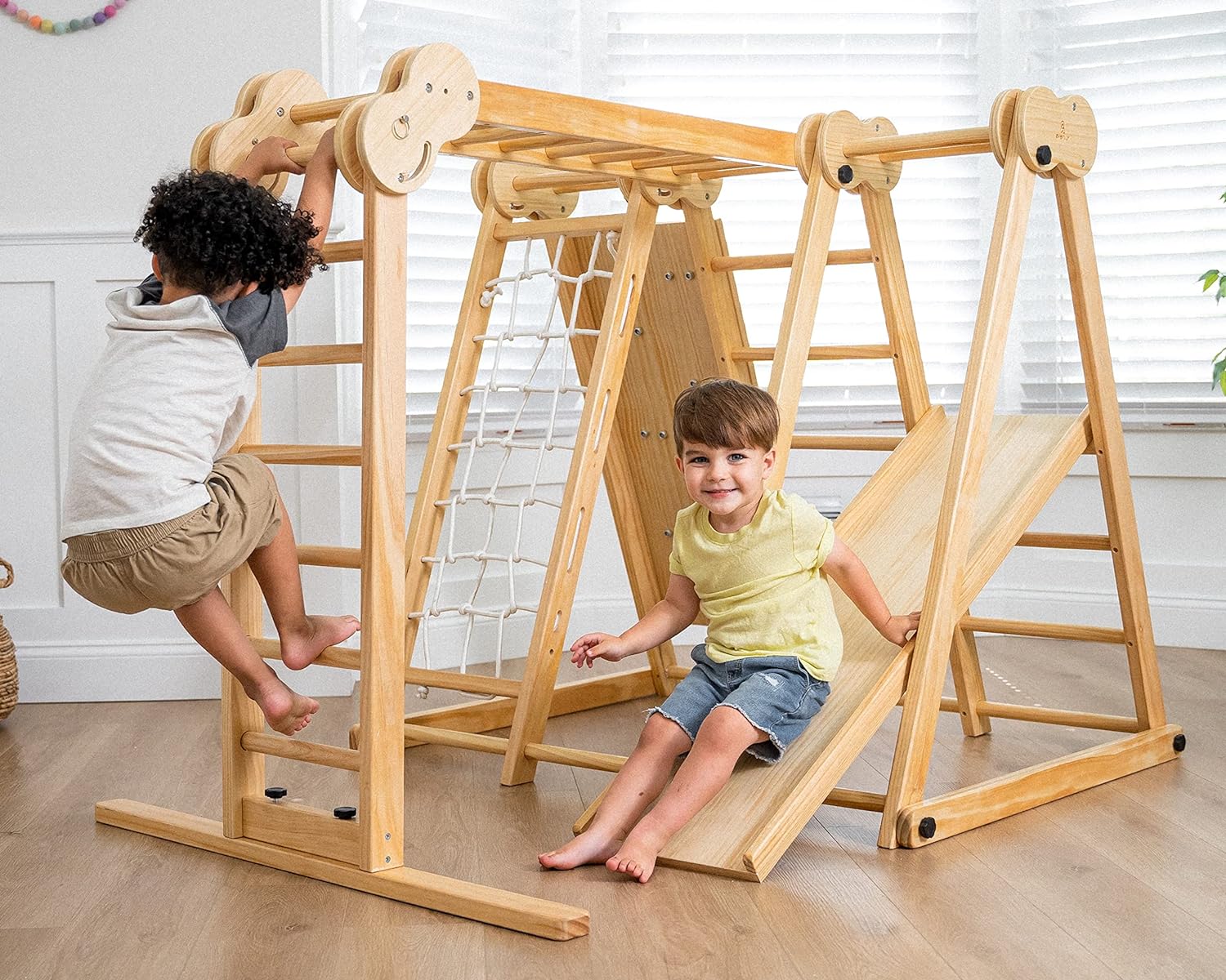 Natural wood 8-in-1 playset with slide, monkey bars, two swings, rock climbing wall, and gym rings for toddlers — view 5a